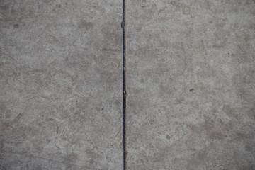 Vertical joint between two grey concrete slabs