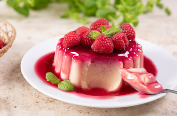 Delicious panna cotta dessert with raspberries sauce