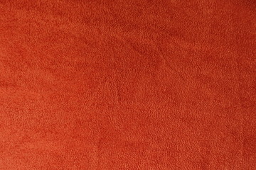 Reddish orange artificial suede fabric from above