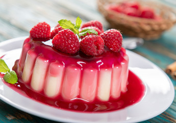 Delicious panna cotta dessert with raspberries sauce