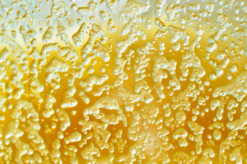 Macro photo of honey. Yellow honey smeared on the glass jars. Abstract yellow texture. Selective focus.