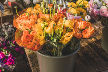 Bouquets of orange ranunculus on flower street market
