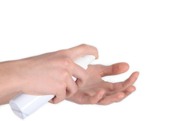 Hands hold a bottle of disinfectant spray and spray. Hands in the process of cleaning with a medical disinfecting liquid, on a white background, close-up