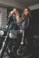 Naklejka na ściany i meble Sexy biker girls sitting on vintage custom motorcycles