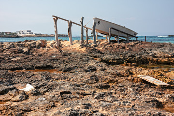 Boats pulled ashore in a port of a fishing village in Formentera in the Balearic islands of Spain.