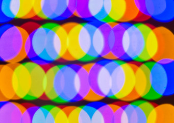 defocused light of multi-colored light bulbs at night