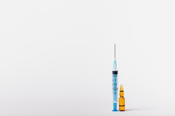 Syringe and vaccine on a white background.  Injection on a white background