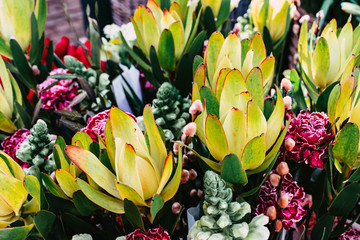 Colourful nixed flowers bouquets on street market, soft focus
