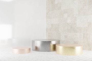 Golden and silver cylinder podiums with light reflections on wooden floor near the tiles wall.