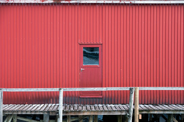 Metallic door and wall of warehouse on coastline in fishing village