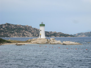 Capo Testa lighthouse in Sardinia on the rocks overlooking the blue sea