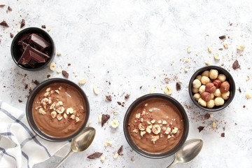 Protein chocolate smoothie with banana and nuts. Top view with copy space. Healthy food.