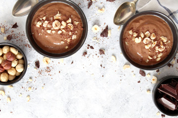 Protein chocolate smoothie with banana and nuts. Top view with copy space. Healthy food.