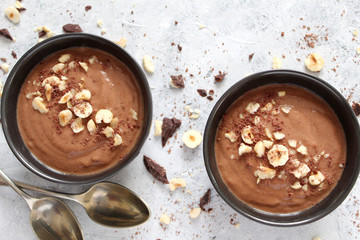 Protein chocolate smoothie with banana and nuts. Top view with copy space. Healthy food.