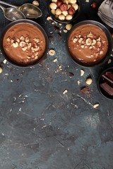 Protein chocolate smoothie with banana and nuts. Top view with copy space. Healthy food.