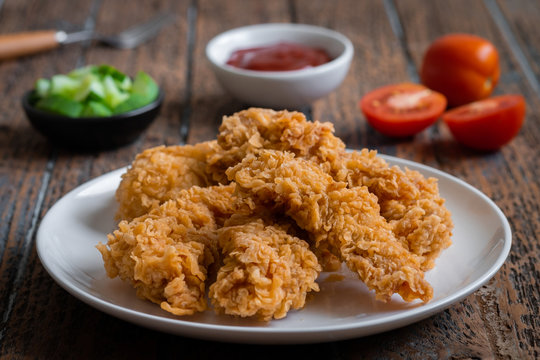 Crispy Fried Breaded Chicken Strips On Plate And Ketchup.