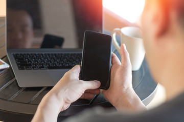 Official professional Business man using multichannel services with internet wifi 5G on smartphone and online tablet in coffee shop.City lifestyle businessman hands working using mobile phone concept