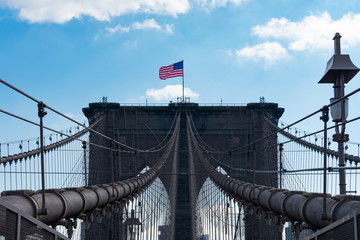 Arches on the Brooklyn Bridge with an American Flag in New York City