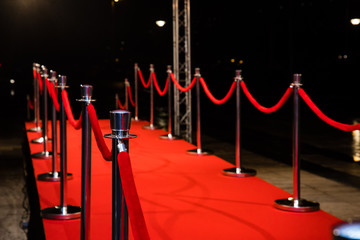 Red carpet with barriers and red ropes.