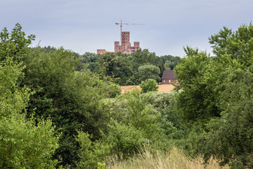 Distance view of construction site of castle in Stobnica village in Forest in Greater Poland region of Poland