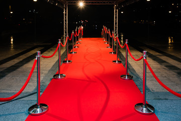 Red carpet with barriers and red ropes.