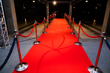 Red carpet with barriers and red ropes.