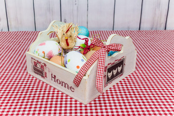 Wooden box with eggs and chicken on the table. Easter concept