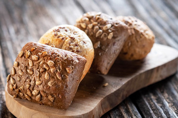 hot cross buns with poppy seeds on a wooden background