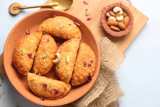 Popular Holi Snack known as Karanji or Gujia is Served on earthen platter. (Holi Concept)