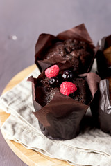Tasty Chocolate Muffins Decorated with Berries on Old Wooden Tray Gray Background Dessert for Tea or Coffee Vertical