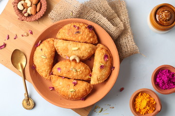 Popular Holi Snack known as Karanji or Gujia is Served on earthen platter. (Holi Concept)