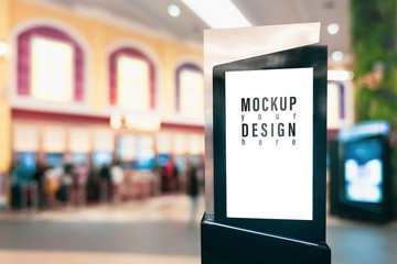 Mockup blank empty advertising light box for your advertisement artwork, text or media content with blurred image of ticket sales counter at movie theater. Mock up concept for advertisement marketing