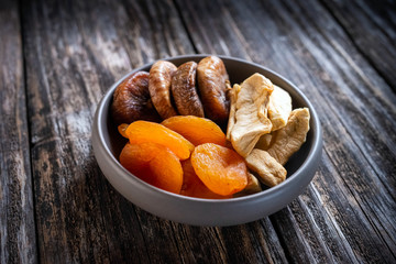 dried fruit in a bowl on wooden table