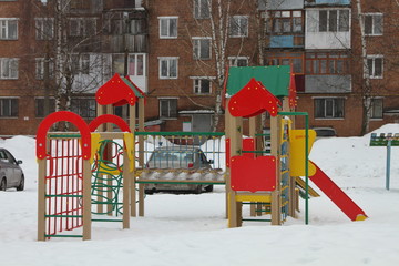 Fototapeta na wymiar Children's town in the yard in winter in the snow