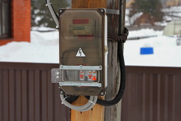 Electric meter hanging on a pillar in the village