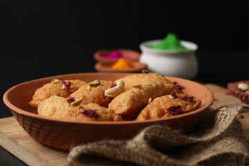 Popular Holi Snack known as Karanji or Gujia is Served on earthen platter. (Holi Concept)