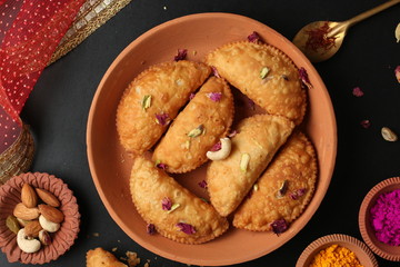 Popular Holi Snack known as Karanji or Gujia is Served on earthen platter. (Holi Concept)