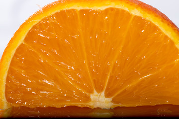 Closeup view on half orange on white background