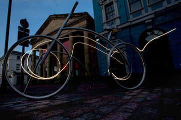 Bike rack at night in the city, energized by speed light