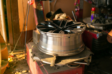 Mechanic changing wheel on car with pneumatic wrench, Photo of car wheel.