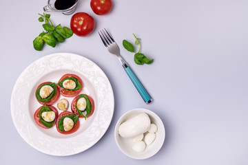 White Plate of Classic Italian Caprese Salad Ripe Tomatoes Fresh Basil Leaf Bowl with Mozarella Cheese Flat Lay Top View Salad and Ingredients Copy Space