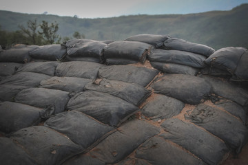 Sandbag in front line. Military bunker base in war zone. Military controlled area