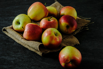 Fresh apples on a dark marble table