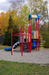 empty playground equipment in park in fall 