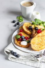 Traditional sweet French toasts with blueberry, dried cherry, mint and coffee. Delicious breakfast. 
