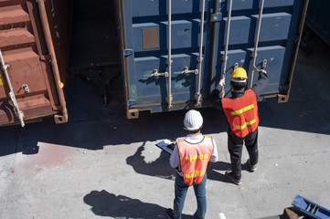 Foreman control loading containers box from cargo freight ship for import export, Foreman control...