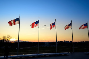 Sunset captured behind the circle of flags at the Washington Monument