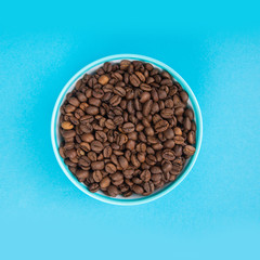 Cup with grains of coffee. Abstraction and coffee minimalism.