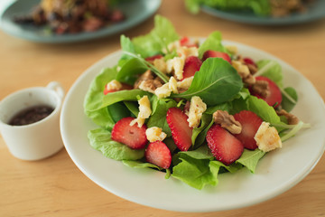 salad with strawberry spinach leaves and feta cheese