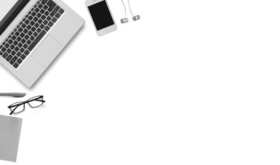 Top view of laptop, mobile phone, small paper, pen and glasses isolated over white background. Copy space, flat lay.